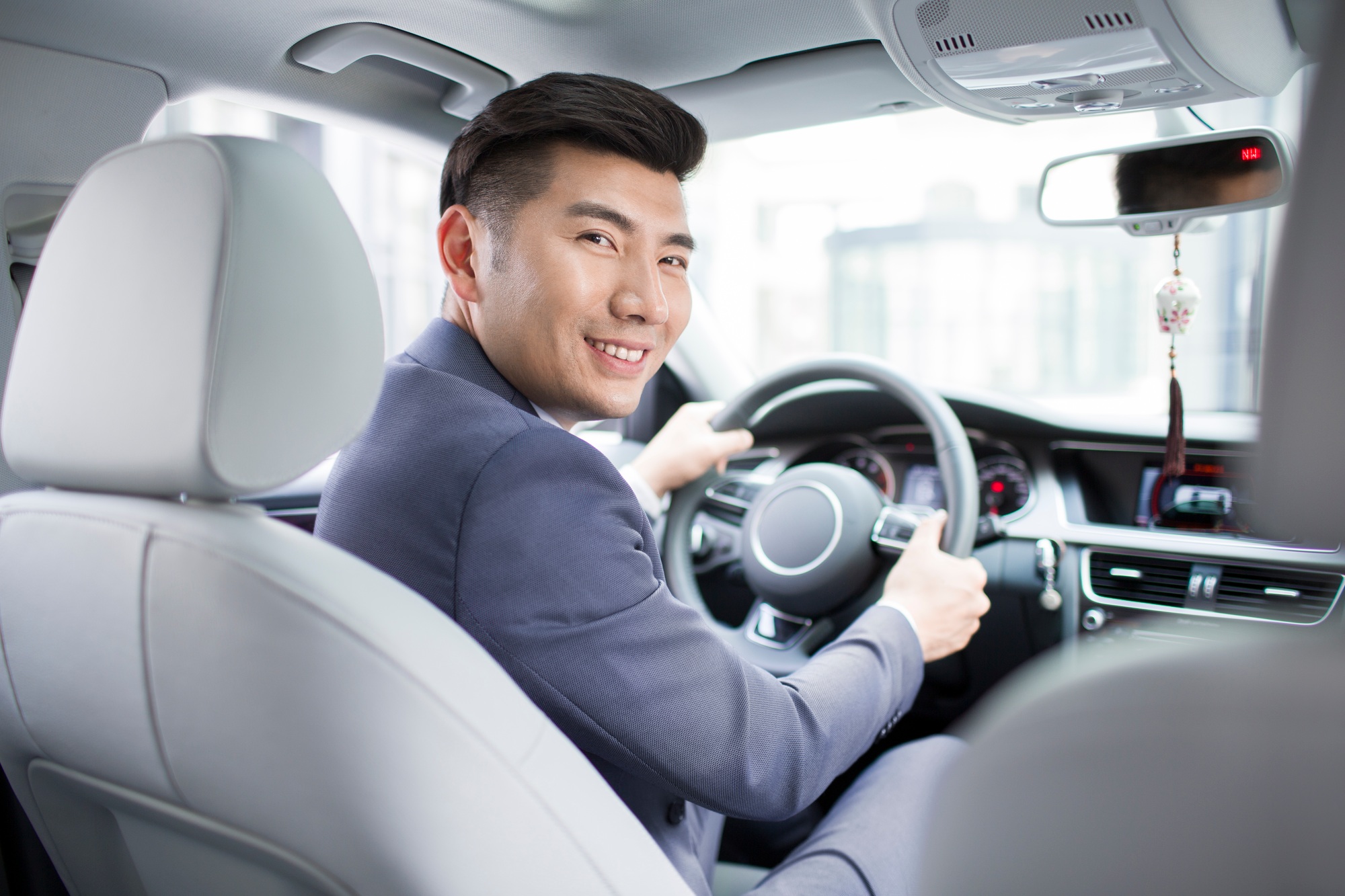 Confident businessman driving car