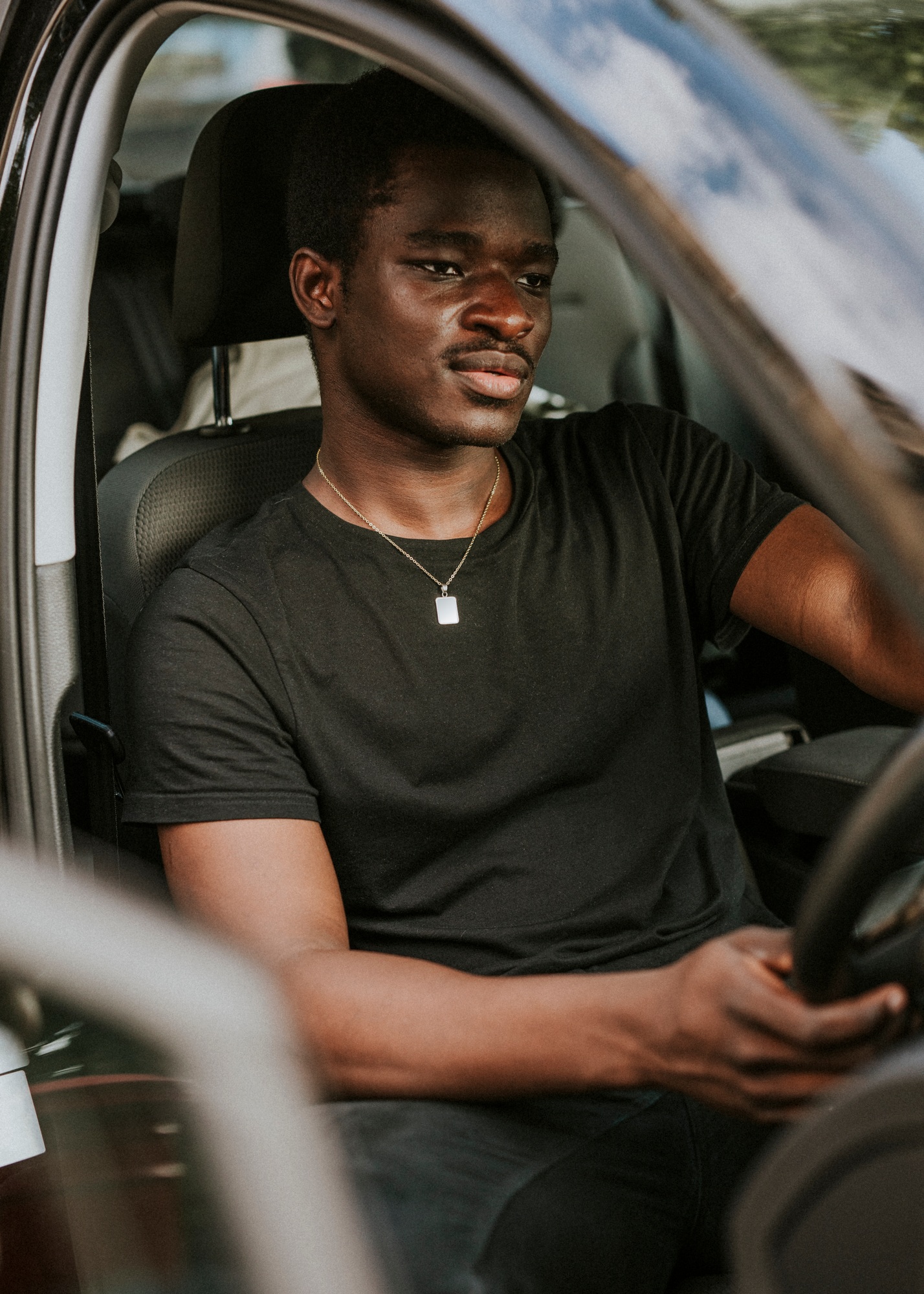 Handsome African American man driving a car